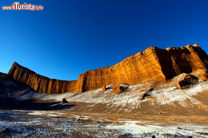 Immagine La Valle della Luna nei pressi di San Pedro de Atacama in Cile. Le roccie dalle tinte arancioni si alternano a croste di sali dalle tonalità chiare, il tutto si fonde in paesaggio lunare o marziano al tramonto - © Jan-Niklas Keltsch / Shutterstock.com
