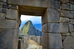 Scorcio di Machu Picchu, Perù - Un suggestivo panorama delle vette andine che circondano il sito di Machu Picchu visto dall'interno di un edificio in pietra all'interno della ...