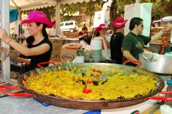 Una grande paella cucinata in uno stand all'aperto in occasione della festa religiosa Romeria San Barnabe a Marbella, Spagna - © Arena Photo UK / Shutterstock.com 