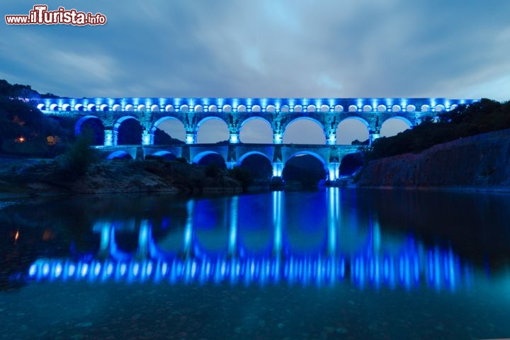 Immagine Acquedotto romano a Vers, nella Linguadoca Rossiglione: il Pont du Gard viene illuminato con delle luci colorate - © Matej Kastelic / Shutterstock.com