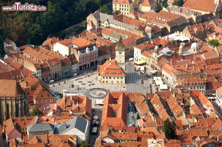 Immagine Fotografia aerea del centro storico di Brasov, Romania - Si presenta in tutto il suo splendore il cuore storico di Brasov soprattutto se visto dall'alto: la grande Piazza del Consiglio, con la sua forma rettangolare, è circondata da palazzi e dimore d'epoca ma anche da chiese e musei. A racchiudere la città ci sono anche le mura difensive costruite nel XIII secolo dai cavalieri teutonici che fondarono questa colonia mercantile © Martijn van Harteveld / Shutterstock.com