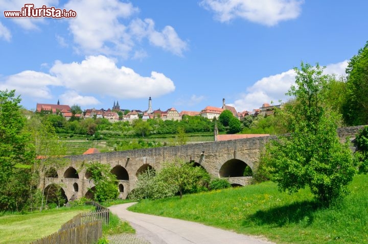 Immagine Ponte alla periferia di Rothenburg ob der Tauber, Germania - Il doppio ponte con i suoi due ordini di arcate una sopra l'altro è stato probabilmente costruito attorno al 1330: si trova ai piedi del versante sud ovest di Rothenburg e fa parte di quella che un tempo era la rotta da Augusta a Wurzburg. Ripristinato nel 1791 dopo che alcune arcate era crollate, il ponte Tauber è stato ampliato nel 1925 ma poi danneggiato dalle truppe tedesche. E' stato riaperto nel 1956 © Scirocco340 / Shutterstock.com