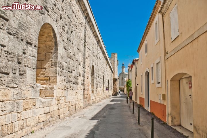 Immagine Strada nella città fortificata di Aigues Mortes, Provenza - Conosciuta anticamente con il nome di Eaux Mortes per via delle lagune e delle acque stagnanti, questo suggestivo borgo della Provenza fu fondato da San Luigi IX° re di Francia che fra il 1240 e il 1249 fece costruire la tour de Constance e un porto in acque profonde da dove partì per la 7^ e 8^ crociata. All'interno della città si snodano caratteristici vicoli che portano alla centrale place St. Louis guardata dall'omonima statua realizzata nel 1849 da Pradier © Alexander Demyanenko / Shutterstock.com