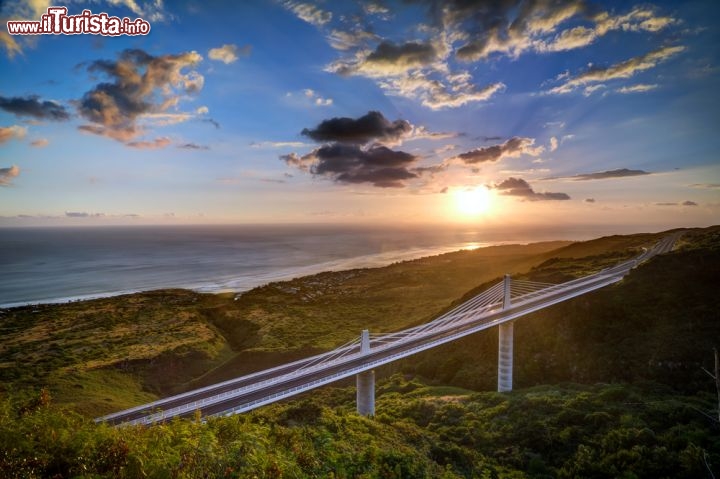Immagine La Réunion, Isole Mascarene, Francia: un tramonto rosato e il Viadotto de la Ravine nel comune di Trois Bassins, nella parte occidentale dell'isola, lungo la Route des Tamarins. A Trois Bassins il litorale è incontaminato e selvaggio e vi si possono praticare il nudismo e il surf  - © infografick / Shutterstock.com
