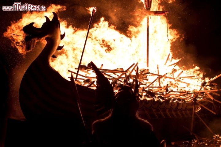 Immagine A Lerwick sulle Isole Shetland per Up Helly Aa. Ogni anno sulle Isole Shetland della Scozia, l'ultimo martedì del mese di gennaio. La giornata prevede una serie di marce da parte di vari figuranti come i Guizer e squadre di guerrieri vichinghi, che poi convergono in un'enorme processione di torce che culmina con il famoso e spettacolare incendio di un galeone vichingo. L'evento richiama migliaia di visitatori tra residenti e turisti che arrivano da ogni parte del mondo per vedere questo originale falò che fornisce un po' di luce e calore al buio e freddo clima delle Shetland. - © Andrew J Shearer / iStockphoto LP