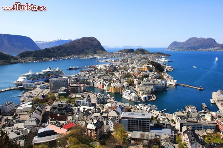 Immagine Panorama di Alesund, nella Norvegia occidentale, vista dal monte Aksla: da qui, oltre alla città, si possono ammirare le isole circostanti e le grandiose Alpi di Sunnmøre. Per conquistare la cima si può salire in auto lungo la strada Borgundveien/Fjelltunveien, ma i più avventurosi preferiranno percorrere a piedi la scalinata di 418 gradini che parte da Byparken ai piedi del monte. Nel parco cittadino, con un'ampia area verde attrezzata per i bambini, incontrerete la statua di Gange-Rolv (Rollone), il vichingo nativo di Alesund che nel 911 divenne il primo conte di Normandia - © Flash-ka / Shutterstock.com