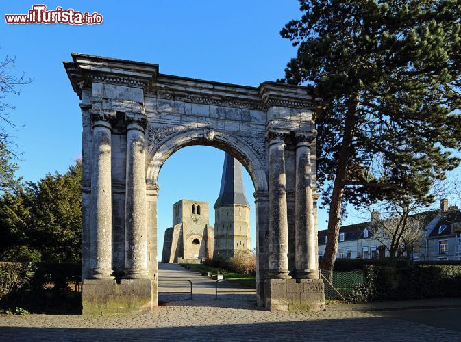 Immagine L'arco della Porte de Marbre, uno degli antichi accessi alla città di Bergues e, sullo sfonfo, le vestigia del complesso dell'abbazia di Saint Winoc.