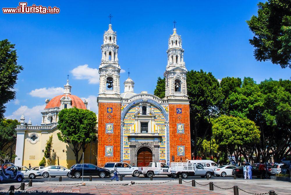 Immagine Auto parcheggiate di fronte alla chiesa di Nostra Signora di Guadalupe a Puebla, Messico. La facciata dell'edificio religioso è realizzata con le famose piastrelle smaltate tipiche di questo territorio - © Madrugada Verde / Shutterstock.com