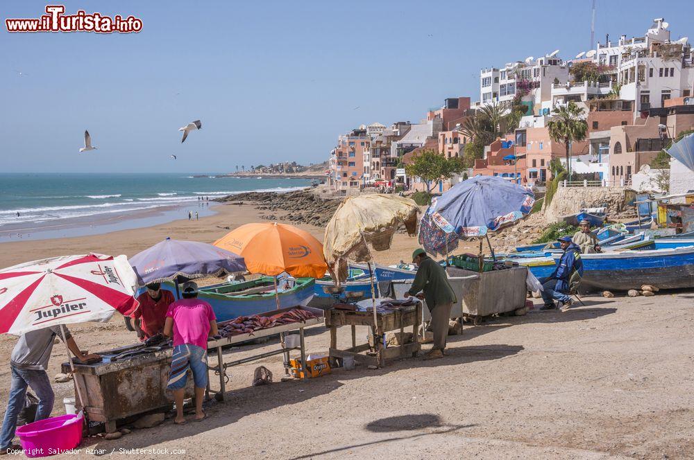 Immagine Bancarelle per la vendita del pesce sulla spiaggia di Taghazout, Marocco. La pesca, così come la produzione di olio d'argan e il turismo, rappresenta una delle principali fonti economiche di questo paese - © Salvador Aznar / Shutterstock.com