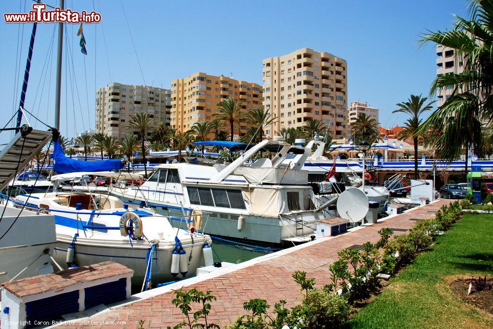 Immagine Barche ormeggiate alla marina di Estepona con palazzi e edifici sullo sfondo, Spagna. Questa cittadina, a circa un'ora di macchina dallo stretto di Gibilterra, è immersa nell'atmosfera caliente dell'Andalusia - © Caron Badkin / Shutterstock.com