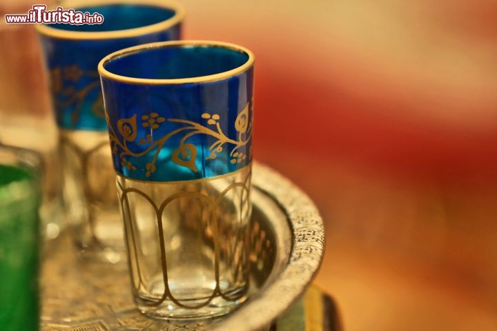 Immagine Bicchieri per il the nel souk di Marrakech, Marocco - Trasparenti, colorati o con preziose rifiniture dorate: i bicchierini in cui sorseggiare il the marocchino si possono acquistare nelle botteghe del souk di Marrakech assieme a splendidi vassoi intarsiati