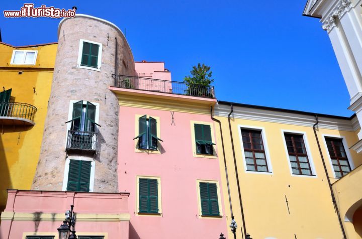 Immagine Uno scorcio della centralissima Piazza Cassini: un trionfo di colore - Piazza Cassini, con le sue splendide case colorate e l'elegante e maestosa Chiesa di Santo Stefano, rappresenta l'ingresso alla Pigna, il cuore storico della città. Proprio per la sua importanza storica e geografica, questa bella piazza viene regolarmente scelta durante l'anno come sede di eventi di varia natura e mercatini. - © maudanros / Shutterstock.com