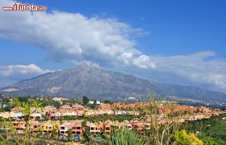 Immagine Case colorate ai piedi della montagna La Concha a Marbella, Spagna. A 1200 metri sul livello del mare, questo monte è uno dei simboli di Marbella per via della sua particolare forma caratterizzata da profondi solchi. Andando alla sua scoperta vi si possono ammirare ulivi, cespugli di bacche, alberi di noce, aquile, gufi e capre - © Nick Stubbs / Shutterstock.com