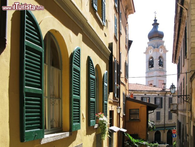 Immagine Chiesa parrocchiale di Santo Stefano a Menaggio, Como, Lombardia. A questo complesso architettonico, costituito dalla chiesa e dal campanile, si accede tramite una scalinata esterna  lungo tutta la facciata dell'edificio di culto. Santo Stefano ha pianta longitudinale a tre navate con cappelle laterali e sacrestia, copertura a tetto e manto in lastre di pietra. Il bel campanile, a pianta quadrangolare con cupola con manto in rame, sorge sul lato nord - © Alexander Chaikin / Shutterstock.com