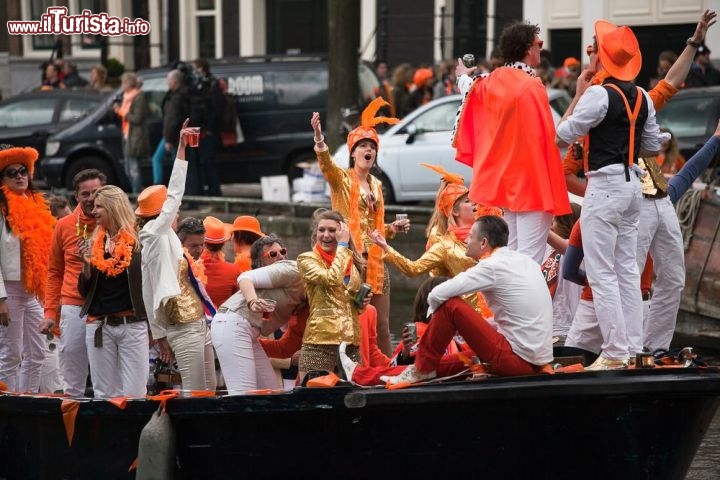 Immagine Festeggiamenti per il Koningsdag a Amsterdam, Olanda - A scendere in piazza in occasione della festa del re sono circa due milioni di persone, fra cittadini e turisti, che si ritrovano in occasione del compelanno del sovrano per commemorarne la nascita. Durante questa festa la città di Amsterdam si tinge di arancione, colore tradizionale della monarchia olandese dando origine ad un fenomeno chiamato Oranjegekte. Bandiere, striscioni, abbigliamento, cibi e bevande colorano di arancione la capitale dove anche l'acqua delle fontane viene tinta dello stesso colore © Cloud Mine Amsterdam / Shutterstock.com