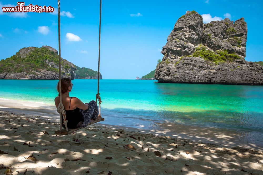 Immagine Una giovane ragazza seduta su un'altalena all'Ang Thong National Marine Park, Thailandia. Un vero e proprio paradiso per gli amanti del relax e della natura rigogliosa.