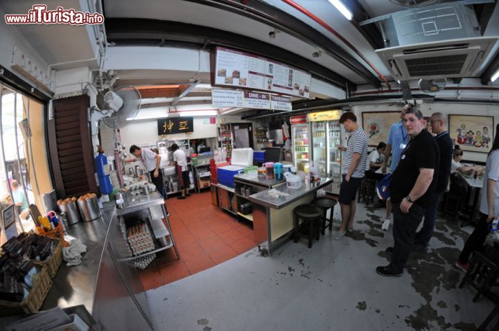 Immagine I locali del celebre Ya Kun Kaya Toast dove scegliere le specialità gastronomiche da assaporare seduti nei tavolini esterni. Se volete iniziare la giornata come uno del posto, o se cercate un luogo in cui respirare l'atmosfera più autentica di Chinatown e della sua cucina, non perdetevi questo coffeshop. Fra simpatiche cameriere che vi porteranno caffè e toast da imburrare accompagnati da tovaglioli delle serie Disney più famose e cuoche intente a cucinare la vostra colazione, lo Ya Kun Kaya Toast è un must da non perdere - © Sonja Vietto Ramus