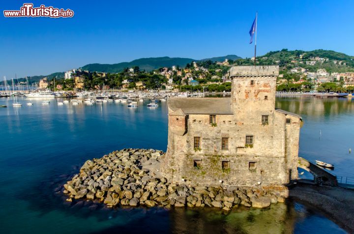 Immagine Il Castello sul Mare di Rapallo - costruito nel XVI secolo, questo splendido castello, considerato un vero e proprio simbolo di Rapallo, è situato all'estremità del Lungomare Vittorio Veneto, di cui si pone come elegante e maestosa appendice. Una particolarità che rende davvero unica questa piccola fortezza, è il suo essere circondata dal mare e collegata alla terraferma solo tramite un pontile. - © Fausto Lanzetti / Shutterstock.com