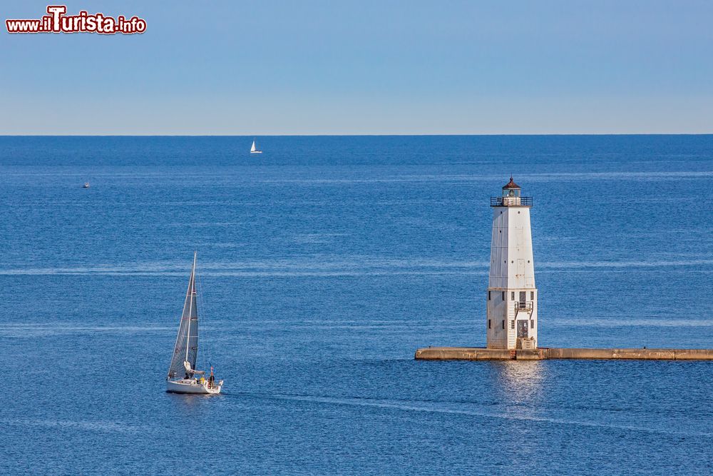 Immagine Il faro sul lago Michigan nei pressi di Frankfort, Stati Uniti d'America, con una barca a vela. Siamo su una scogliera a sud della città. 
