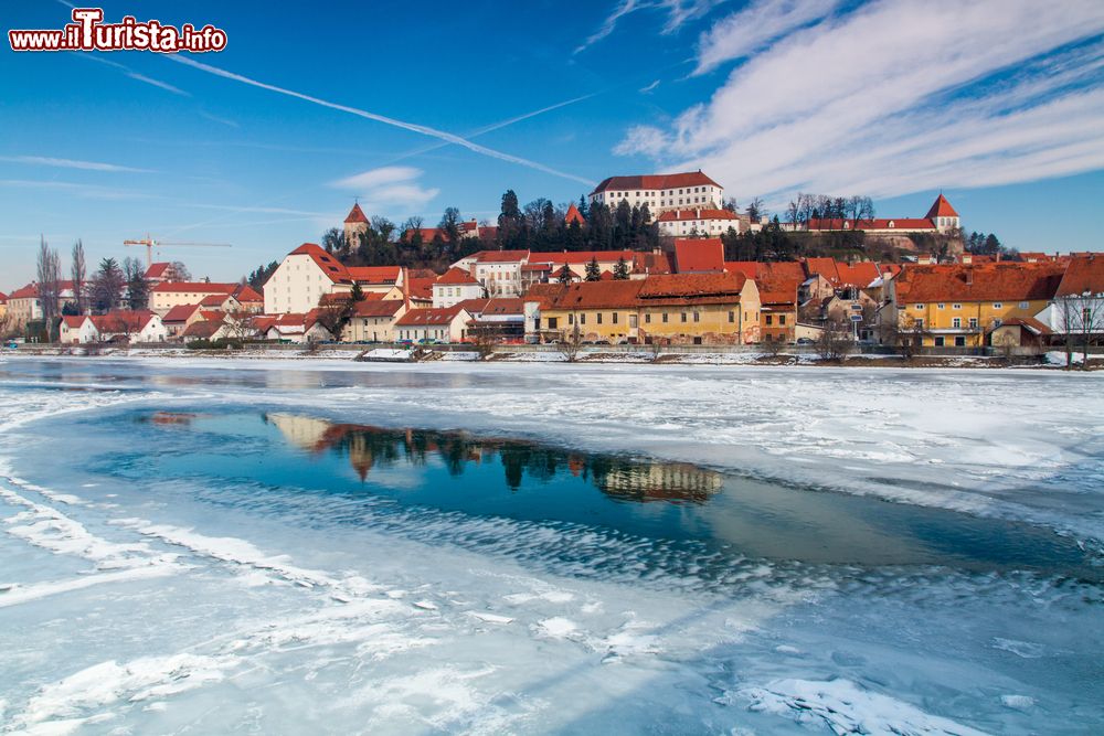 Immagine Il fiume Drava ghiacciato in inverno, Ptuj, Slovenia. Sullo sfondo, la cittadina circondata da una splendida natura.