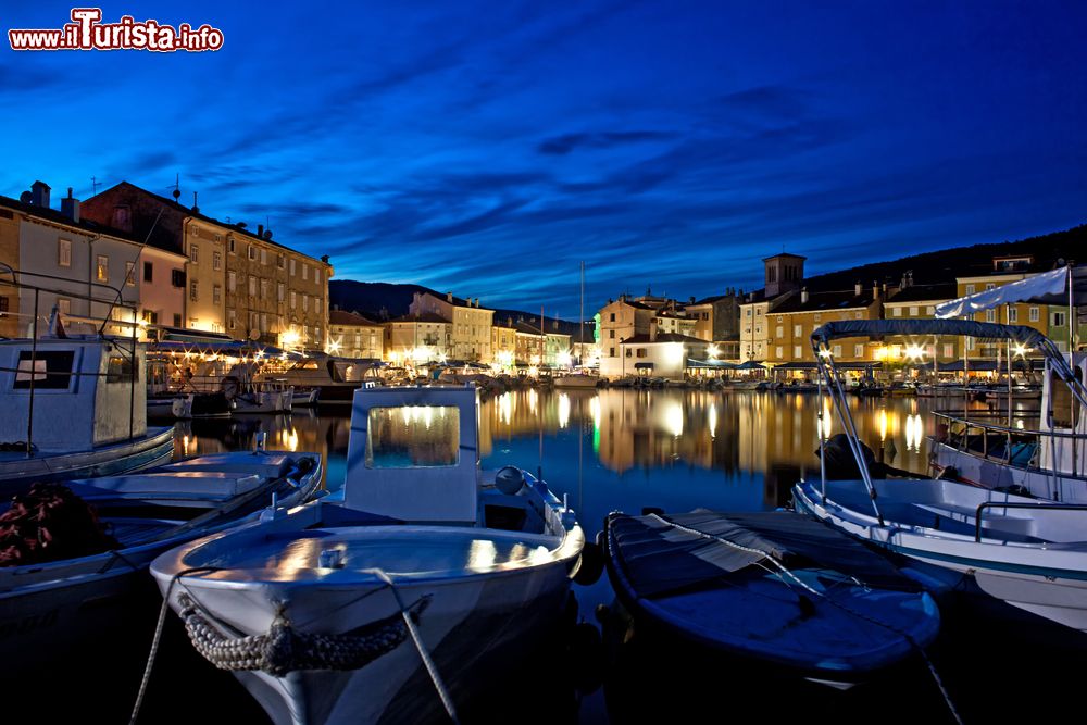 Immagine Il porto di Cres by night, isola di Cres, Croazia. I palazzi illuminati si rispecchiano nelle acque del mare creando un'atmosfera magica.