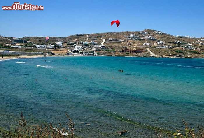 Immagine Korfos, Mykonos: la spiaggia più amata dai surfisti in questa isola della Grecia. Situata in prossimità della città di Mykonos, questa spiaggia particolarmente ventosa è fra le preferite da chi pratica surf e windsurf. L'acqua verde e grandi onde creano un panorama incantevole.