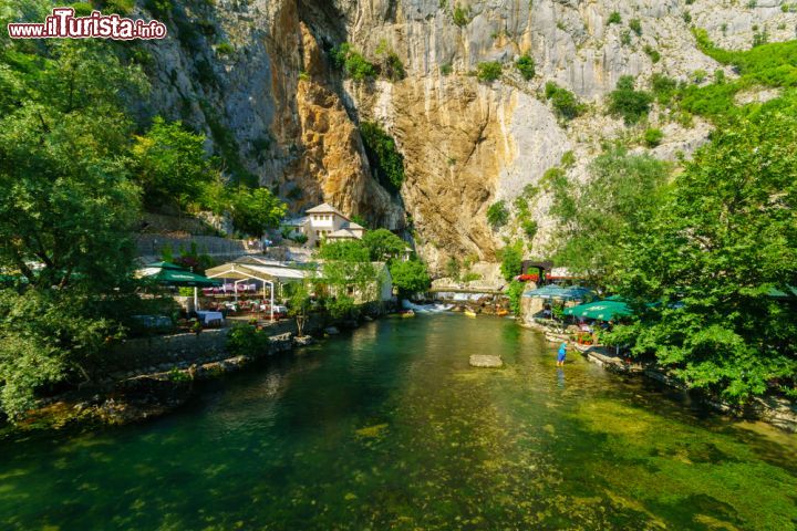 Immagine Lungo il fiume Buna: natura e spiritualità - lo spettacolo naturale della fonte del fiume Buna è tra i più belli della Bosnia-Erzegovina. In questa foto possiamo notare come la natura imponente della montagna e del fiume vadano a creare un'atmosfera quasi fiabesca, arricchita ancora di più dalla spirituale bellezza del monastero derviscio. - © RnDmS / Shutterstock.com