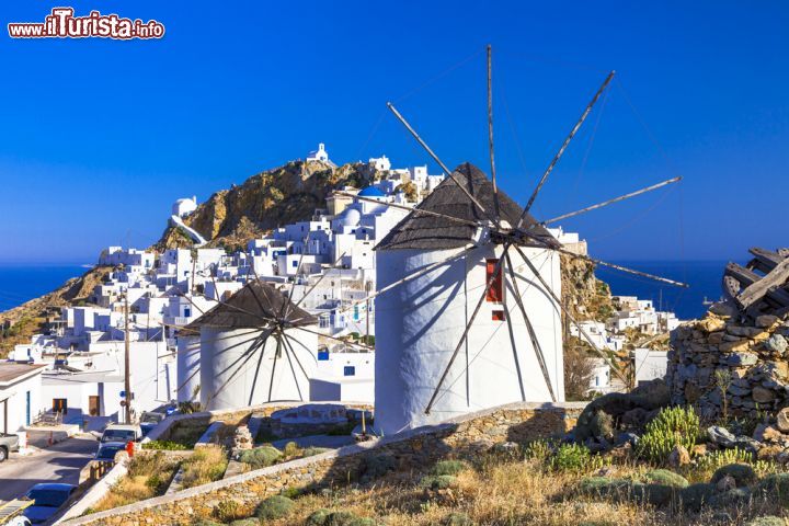 Immagine Mulini a vento a Serifos, Grecia. I caratteristici mulini a vento intonacati di bianco che si trovano nel territorio di quest'isola delle Cicladi. Sullo sfondo la capitale Chora - © leoks / Shutterstock.com