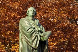 La statua di Martin Lutero nell'autunno della città di Worms, la più antica di tutta la Germania. Fra le molte che ritraggono il teologo iniziatore della confessione del luteranesimo, ...