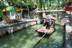 Canale della città fluviale di Zhouzhuang: una barca remi compie un tour del villaggio della Cina