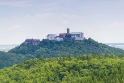 Il Castello di Wartburg visto in lontanaza dalle verdi colline della Turingia in Germania - © bluecrayola / Shutterstock.com
