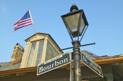 Bourbon e St. Philip Street, New Orleans - La bandiera a stelle e strisce svetta imponente dall'abbaino di un palazzo del Quartiere Francese all'angolo fra Bourbon e St. Philp Street, ...