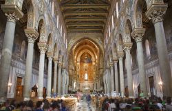 Interno a tre navate del Duomo di Monreale, con il mosaico del Cristo Pantocrate al centro dell'abisde. La catedrale è uno dei capolavori di arte normanna della zona di Palermo e ...