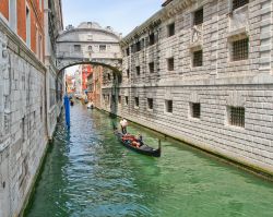 Ponte dei sospiri a Venezia, con gondola di passaggio. Questo ponte coperto collega il Palazzo Ducale con le prigioni, ed è per questo motivo vhe è stato chiamato dei sospiri, ...