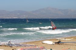 Windsurf davanti alla spiaggia di Toukalia, Paros. A nord di Molos, questa bella spiaggia di sabbia si presenta con un aspetto piuttosto selvaggio che offre ai visitatori l'ombra delle sue ...