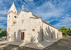 L'antica chiesetta di Sveti Juraj a Primosten, Croazia. Questo bell'edificio religioso è realizzato interamente in pietra bianca ed è uno dei principali luoghi di culto ...
