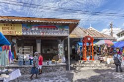 Gente all'antico mercato di Roseau con la storica statua rossa al centro, Dominica. Un tempo questo era il mercato degli schiavi - © Jorg Hackemann / Shutterstock.com