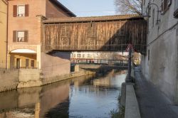 Un antico passaggio in legno al coperto sul Naviglio della Martesana nel centro di Gorgonzola, Lombardia.



