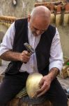 Artigiano all'opera in centro a Tonara in Sardegna: la realizzazione di un campanaccio per una mucca