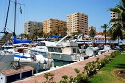 Barche ormeggiate alla marina di Estepona con palazzi e edifici sullo sfondo, Spagna. Questa cittadina, a circa un'ora di macchina dallo stretto di Gibilterra, è immersa nell'atmosfera ...