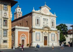 Gente a passeggio di fronte alla facciata principale della chiesa di Santo Stefano dei Cavalieri, Pisa, Toscana. La prima pietra di questo luogo di culto dedicato a Santo Stefano papa e martire ...