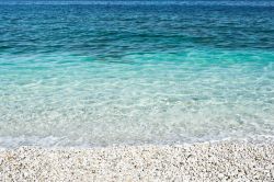 I ciottoli bianchi della spiaggia di Padulella, isola d'Elba, con l'acqua trasparente e cristallina del mare.

