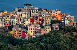 Corniglia (Cinque Terre) al crepuscolo, Liguria. Il borgo, con le sue case colorate a pastello, è collegato al mare da due scalinate.
