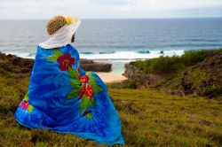 Una donna con il cappello intenta a guardare l'oceano sull'isola di Rodrigues, Repubblica di Mauritius. Quest'isola verdissima è circondata da una laguna di barriera corallina ...