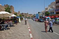 Gente a spasso per le strade di Asilah, Marocco. Asilah è una cittadina fortificata nel nord del Marocco, a circa 46 km da Tangeri. Nel 1471 fu conquistata dai portoghesi che la occuparono ...
