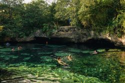 Gente nuota in un cenote a Puerto Aventuras, Quintana Roo, Messico. In America Centrale e nle Messico meridionale il cenote è una grotta con acqua dolce. Si tratta di grotte carsiche ...