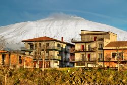 I palazzi di Bronte e sullo sfondo l'Etna innevato (Sicilia)