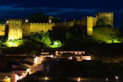 Il castello di Silves fotografato di notte, Portogallo. I resti del glorioso passato di questa città sono visibili in tutta Silves a partire dall'imponente castello di mattoni rossi ...