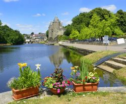 Il fiume Oust e il castello di Josselin (Bretagna) in una giornata di sole, Francia. Le maestose torri del maniero si riflettono sul corso d'acqua.

