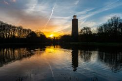 Il parco pubblico Maria Hendrika al tramonto a Ostenda, Belgio, con la torre dell'acqua. I colori del cielo si riflettono sul lago artificiale.



